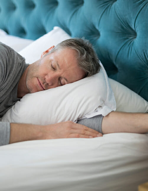 man sleeping in bed