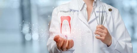 Dentist Holding Large Photoshopped Tooth with Red Nerves