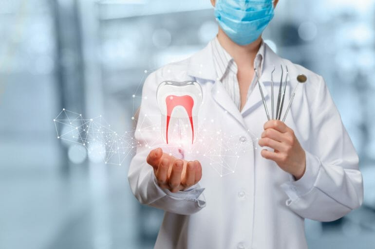 Dentist Holding Large Photoshopped Tooth with Red Nerves