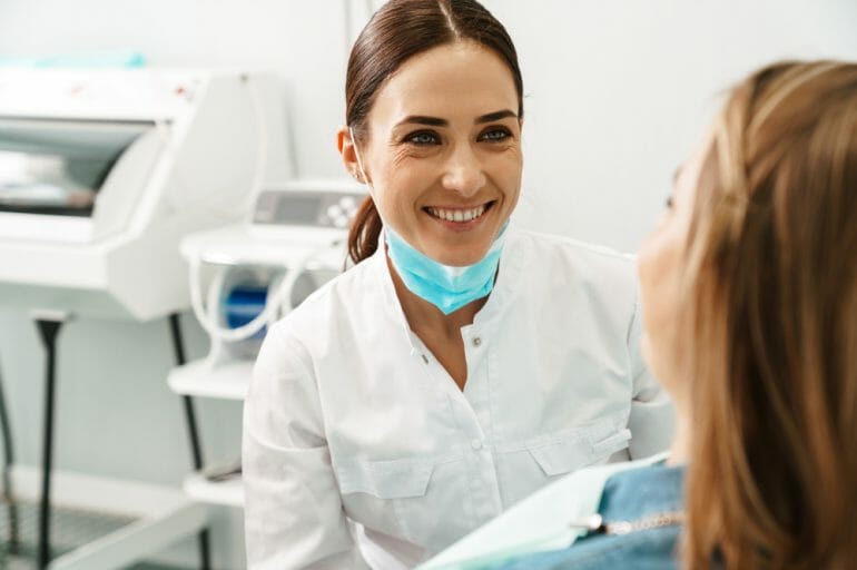 Dentist Smiling at Patient