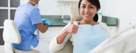 Woman Giving Thumbs Up in Dental Chair